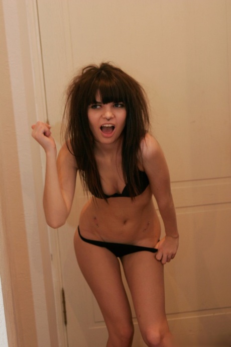 Petite teen Kaira 18 smokes a cigarette while getting naked in her bedroom
