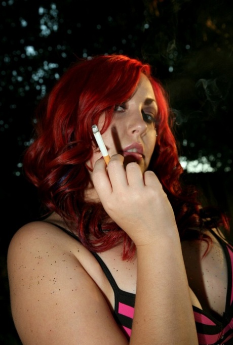 Bad girl Jessa uncups her boobs while smoking a cigarette outdoors